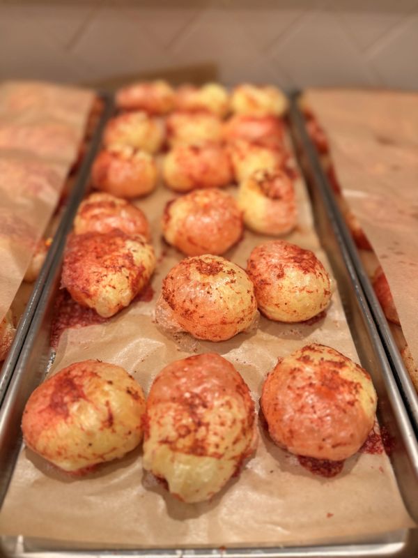 Tray of baked cheese bread rolls.