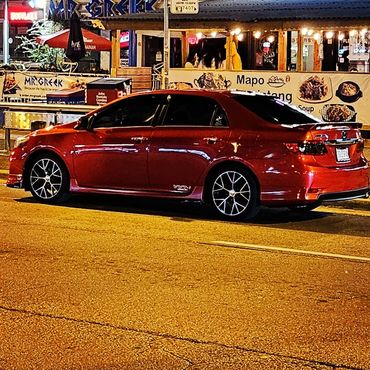 Custom 2011 red Toyota Corolla.