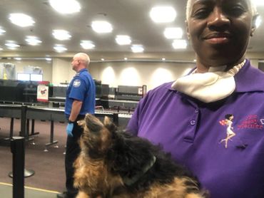 Woman in purple with puppy.