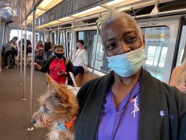Woman with dog on train.