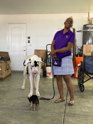 Woman standing with large dog.