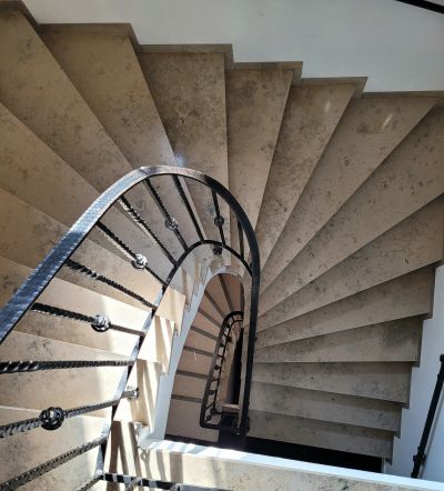 Looking down spiral stone staircase