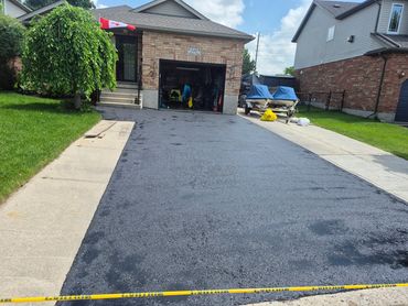 Newly paved driveway in front of a house.