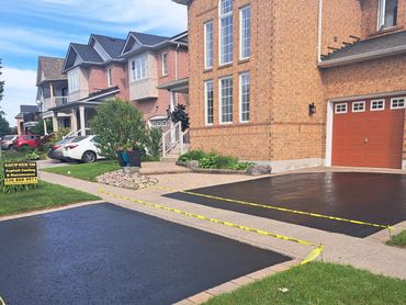 Asphalt driveway restored with professional sealcoating