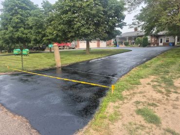 Smooth black driveway following sealcoating service