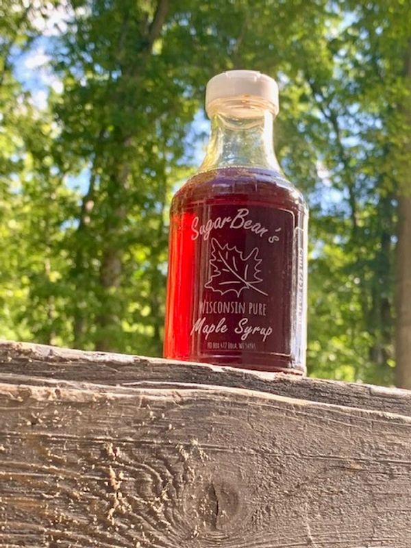 A bottle of Sugar Bear's Wisconsin Pure Maple Syrup.