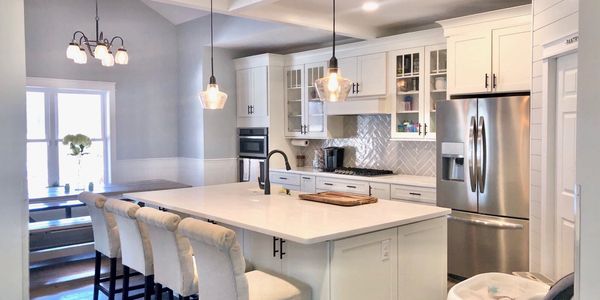 Custom Solid Surface Island and Countertops m, custom cabinets and lighting for kitchen remodel 