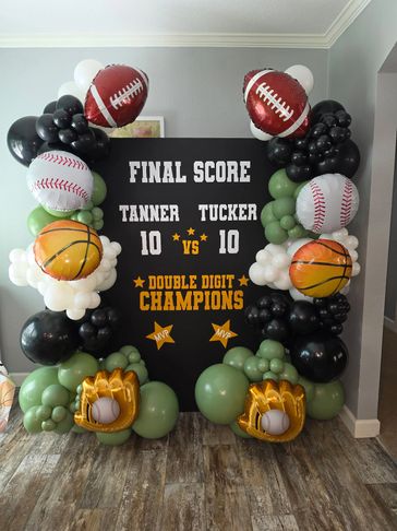 Decorative sports-themed balloon display celebrating a tied game between Tanner and Tucker.
