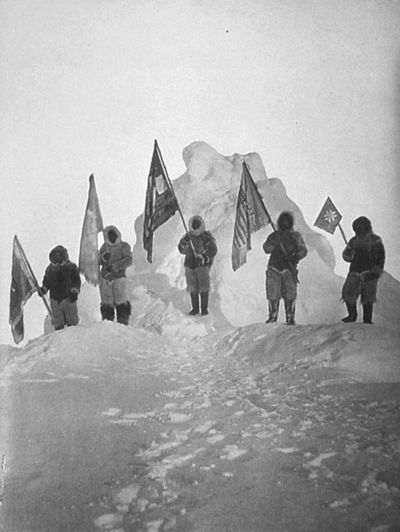 Robert Peary and sledge party with flags at North Pole. April 1909. 