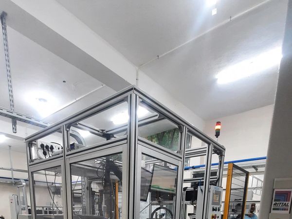 Modern automated machinery setup in a brightly lit industrial space.