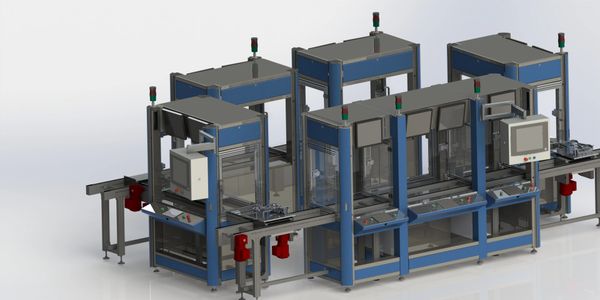 Automated industrial assembly line with conveyor belts and control panels.