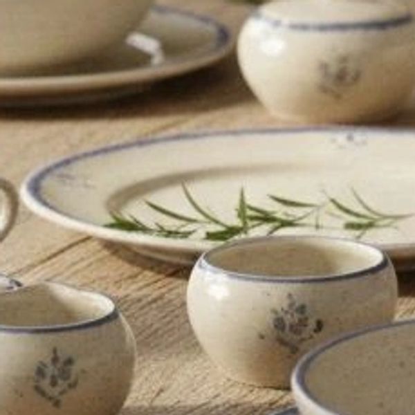 Close-up of rustic ceramic dinnerware with floral details.