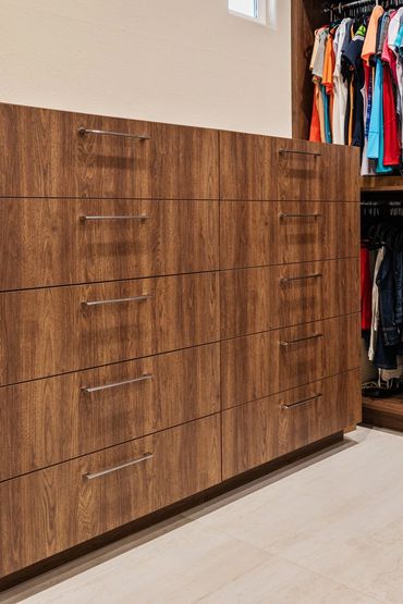 Custom cabinets made for modern closet design with English Walnut panels by American Laminate