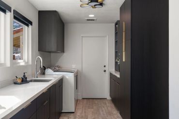 Beautiful home design with integrated floating custom cabinets finished in Black Woodgrain by Egger