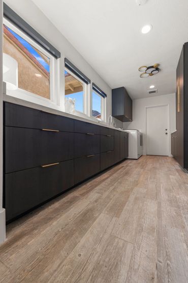 Beautiful home design with integrated floating custom cabinets finished in Black Woodgrain by Egger