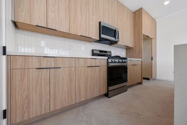 Olmo Miele by Salt used for custom cabinets in modern kitchen design for beautiful Yucca Valley home