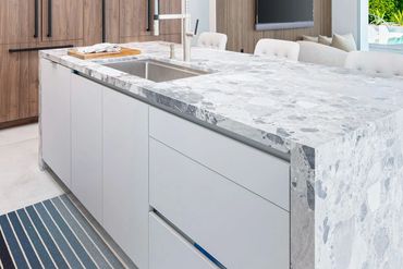 Modern kitchen design in Palm Springs home with custom cabinets clad in Walnut Ambassador