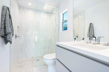 Beautiful modern bath/vanity fitted with custom cabinets clad with Matte Silverlake by Rehau.