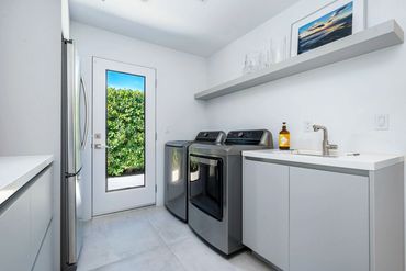 Modern and stylish custom cabinets for laundry room with Matte Silverlake by Rehau finish.