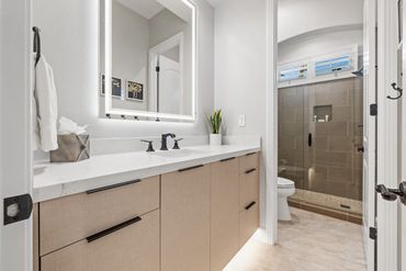 Modern bath/vanity design with integrated custom cabinets in Khaki Linen by Salt for Indio home.