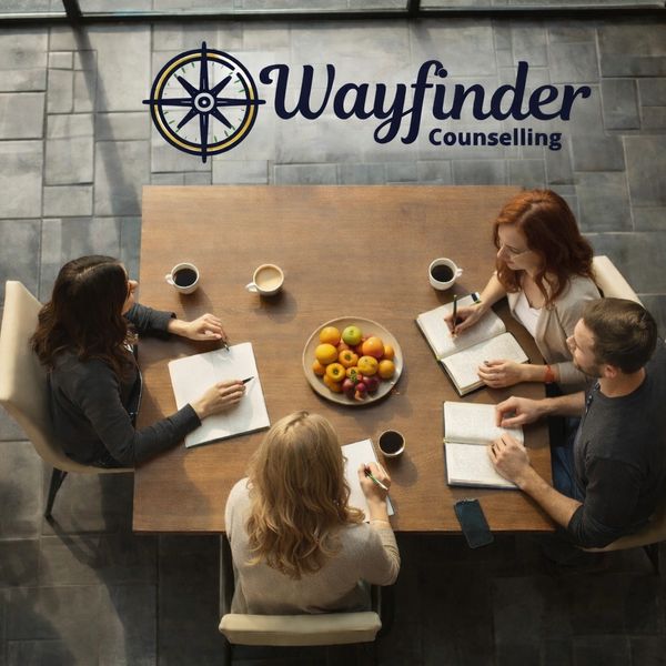 Four people in a counseling session at Wayfinder Counselling.