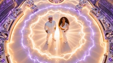 Two people standing inside a glowing electric circle.