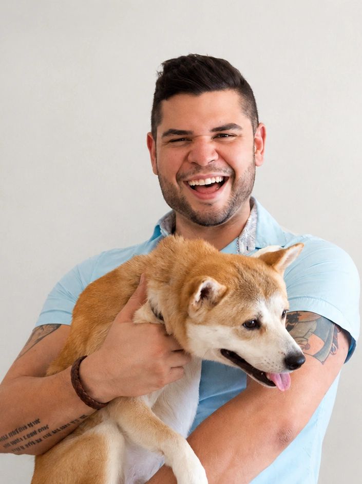 Man joyfully holding a happy dog.