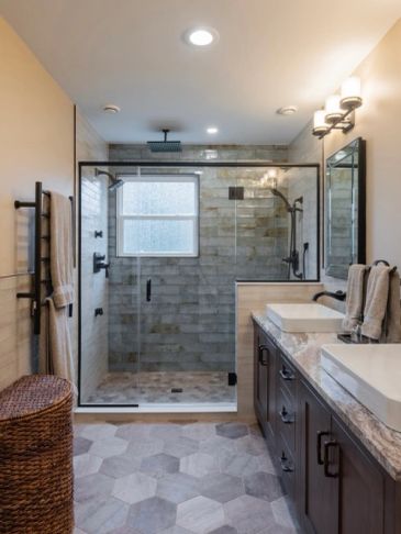 Modern bathroom with glass shower and double sinks.