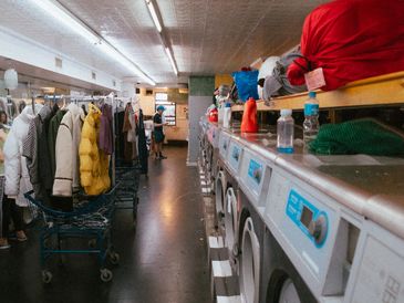 Interior of Montague Cleaners showing clean counters, laundry machines, and organized work area