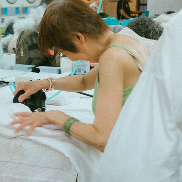 "Staff member at Montague Cleaners carefully inspecting fabric during eco-friendly dry cleaning proc