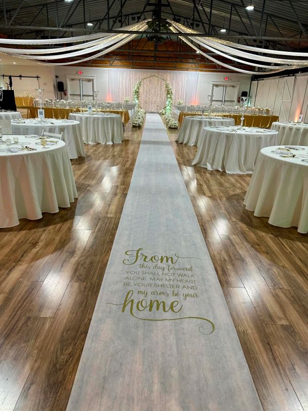 Indoor wedding and wedding reception with aisle runner and wedding decor at The Enchanted Point DFW
