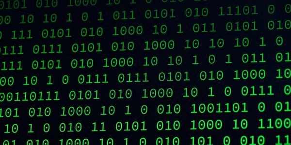 Green binary code scrolling on a black screen representing digital data.