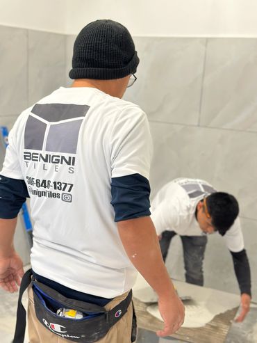 Benignis tiles team member watching a coworker handeling a tiles