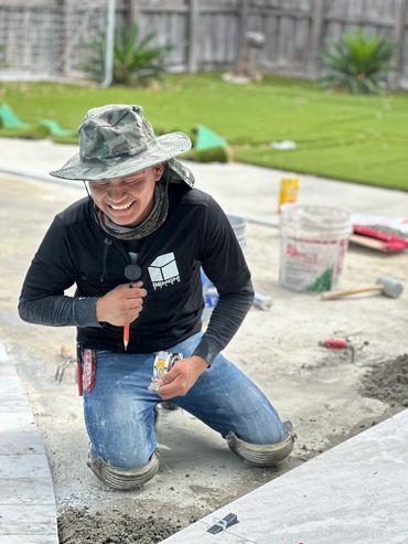 Benignis tiles team member smiling working on the floor