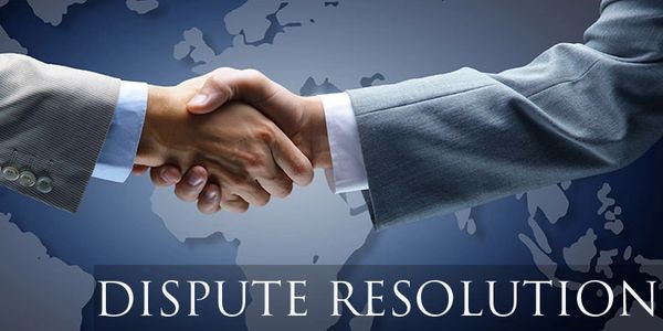 Two business professionals shaking hands symbolizing dispute resolution.