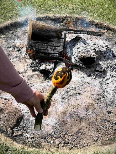The Camp fire beater being held in front of the fire at a Pagan camp.