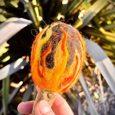 Close up view of the felted flames on the camp fire beater head.