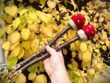 Full length view of two Fly Agaric Beaters on Birch handles. Shows size in hand