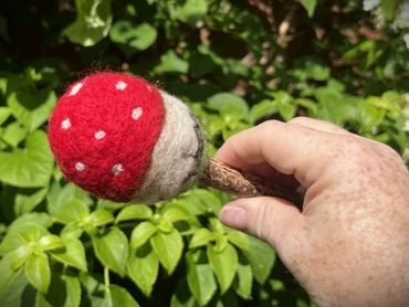 Image of the Fly Agaric inspired beater. A red capped mushroom with white spots on a birch beater
