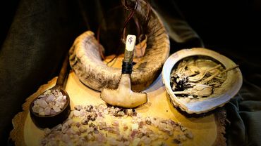 Main image on Mjolnir Hand rattle, presented on ram's horn with crystals.