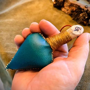 Green snakeshead rattle in hand