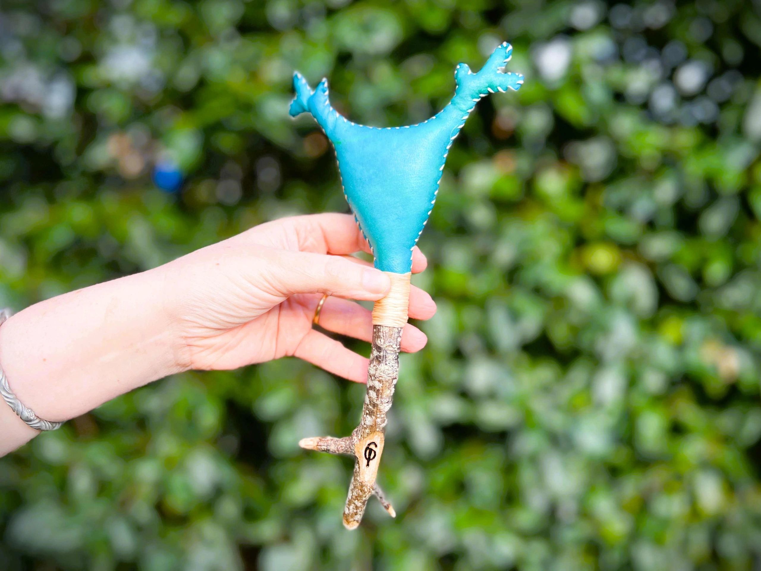 Greeen Cernunnos hand rattle showing antlered crown design on an Oak handle
