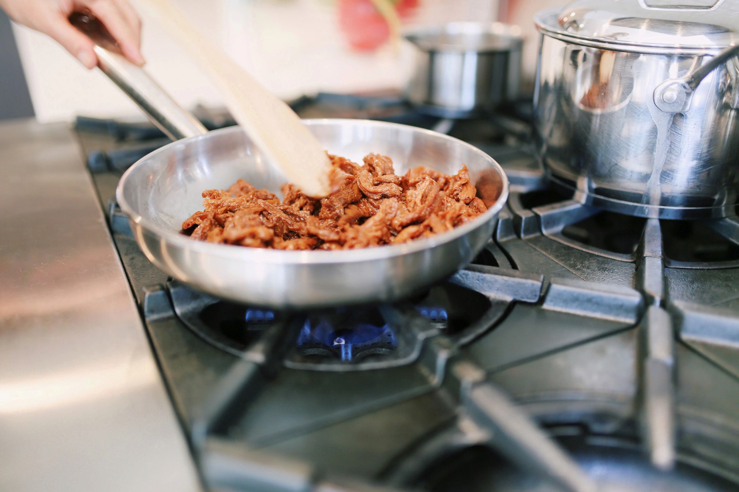Om Noms cooking in a pan on the stove