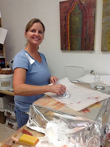 student working on an encaustic monotype
