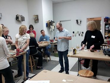 students watching an encaustic demonstration during a workshop