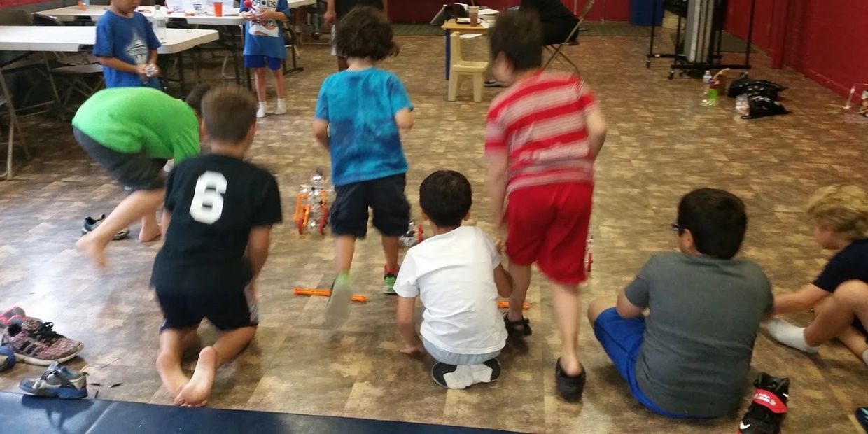 STEM Camp - students learning about gears using iq-keys. Building and racing vehicles