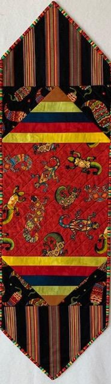 'Groovin' Geckos" table runner is fully reversible.  Measures 11.25 inches wide x 37 long.  $75.
