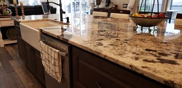 Granite kitchen countertops with dark wood cabinets in a luxury remodel