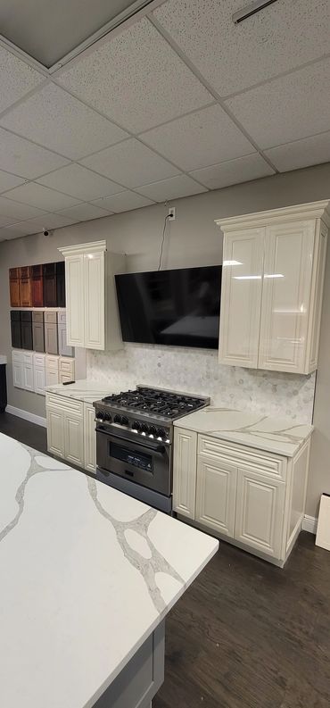 Built-in gas range with tile backsplash in a custom white kitchen