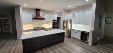 Modern white kitchen with large island and stainless steel appliances